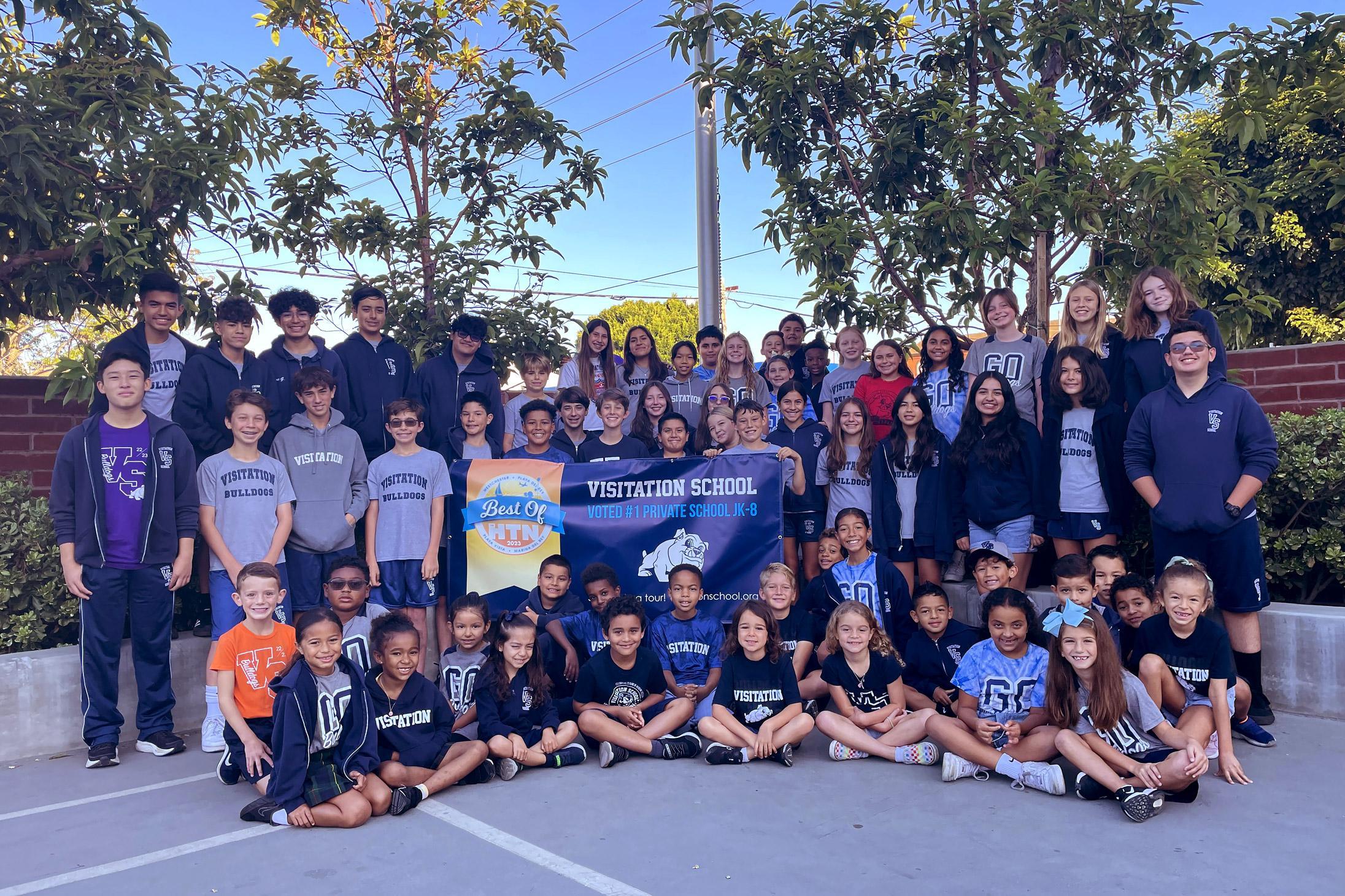 Students Holding Banner "Best Private School"